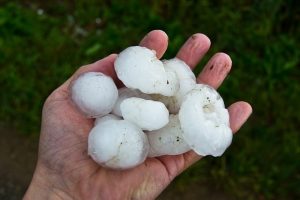 a hand holding large hail stones