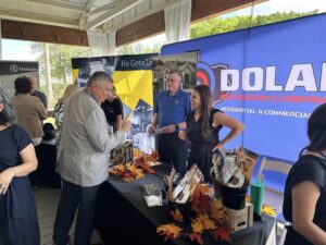 Table set up like a booth at event Dolan Roofing & Construction in San Antonio, TX