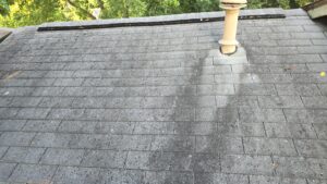 ariel view of damaged roof shingles from age crews working on top of a roof to replace damaged shingles Dolan Roofing & Construction in San Antonio, TX