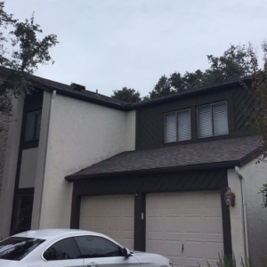 House with black roof and beige wall in San Antonio, TX